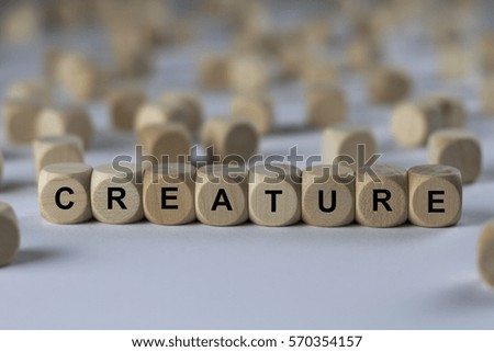 creature - cube with letters, sign with wooden cubes