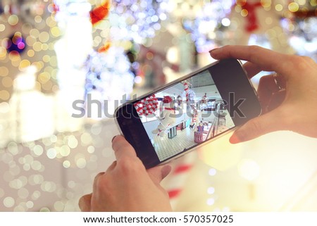 Girl holding the phone and take pictures with bokeh closeup