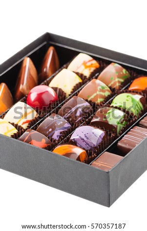 Set of colorful handmade luxury chocolate bonbons in box isolated on white background. Exclusive candies