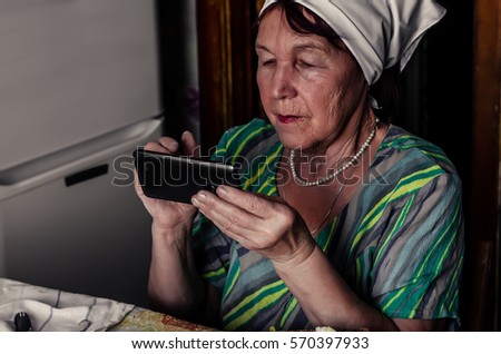 Grandma is holding a phone in his hand