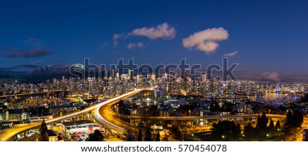 Panoramic view of Downtown Vancouver, Cambie Bridge, and False Creek. Picture taken during a cloudy winter sunset.
