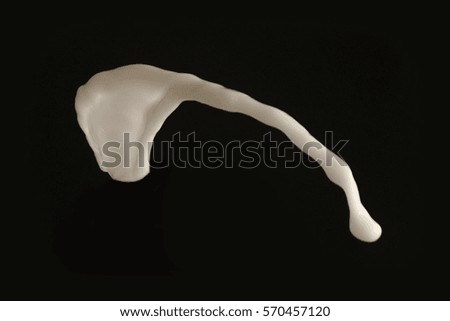 white milk splash black background, isolated yogurt cream motion splashing