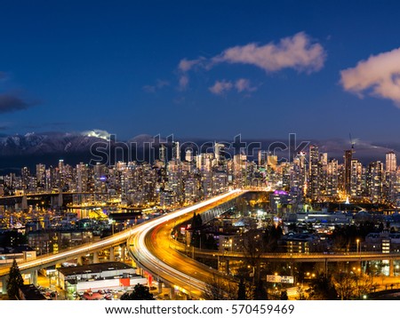 Aerial view of Downtown Vancouver, Cambie Bridge, and False Creek. Picture taken during a cloudy winter sunset.