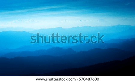 Layers of  blue color  mountains during sunset , concept of tourism and mountaineering 