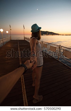 Girl holding a hand man on the beach in Alanya, Turkey