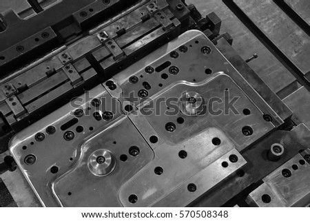 Sheet Metal Stamping Tool Die for Automotive Precision Parts on The Numerical Control Milling Machine Table. Tandem Stamping System. At a High Quality Technology Factory. Black and White Photography.