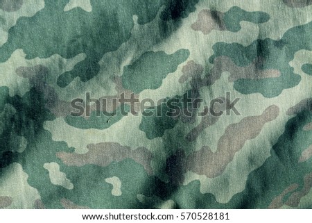 Weathered camouflage cloth texture. Abstract background and texture for design