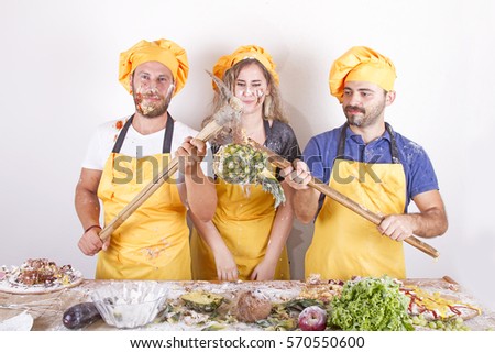 Group of chefs playing with pineapple, fruits and vegetables isolated on white background