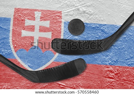 Hockey puck, hockey sticks and image of the Slovak flag on the ice. Concept