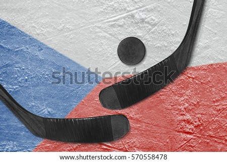 Hockey puck, hockey sticks, and the image of the Czech flag on the ice. Concept