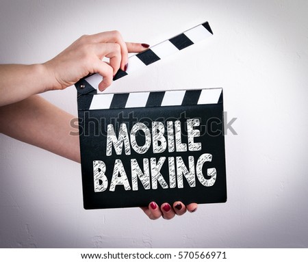 Mobile banking concept. Female hands holding movie clapper 