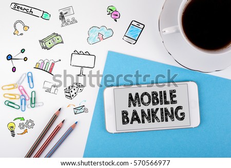 Mobile banking. Mobile phone and coffee cup on a white office desk