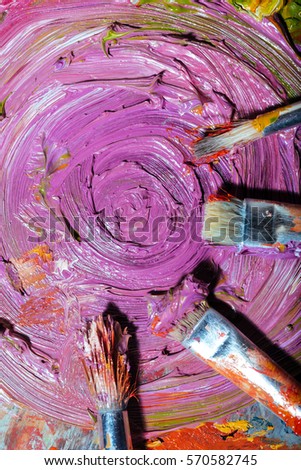 Top view of brushes and violet paint
