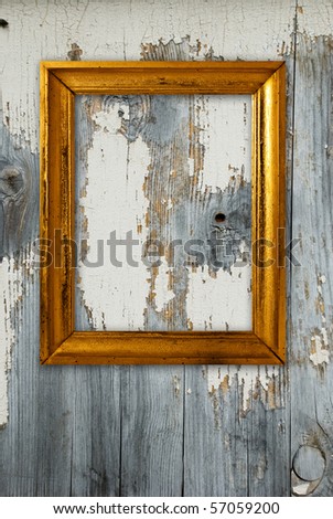 Gold frame on a old wooden wall background.