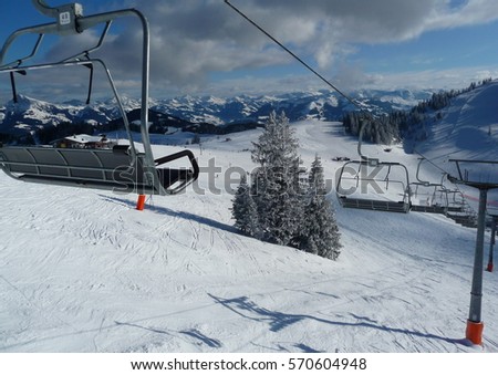 Ski lift in the Alps. A sunny day with beautiful weather on the ridges of the far-sighted