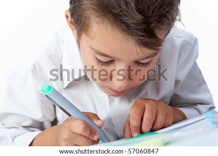 Close-up of school boy drawing picture on paper