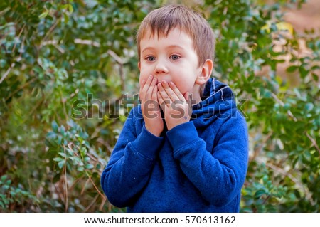 A scared closeup facial expression of a Caucasian child. Afraid of punishment, bad behavior, severe punishment, grounded, scared kid, caught on lie, overwhelmed child, overwhelming stock image.