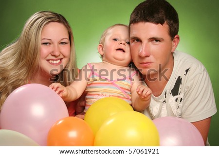 happy young family on green