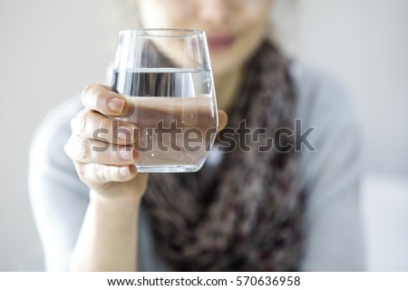 Young woman drinking water Royalty-Free Stock Photo #570636958