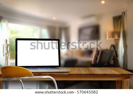 Mock up Blank screen Laptop on wooden table in living room.