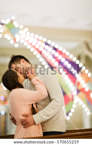 Beautiful couple kissing in shop