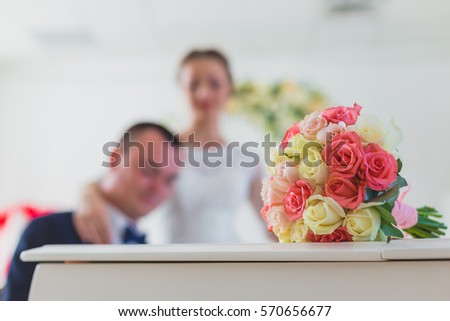 Wedding couple play on piano and bouquet