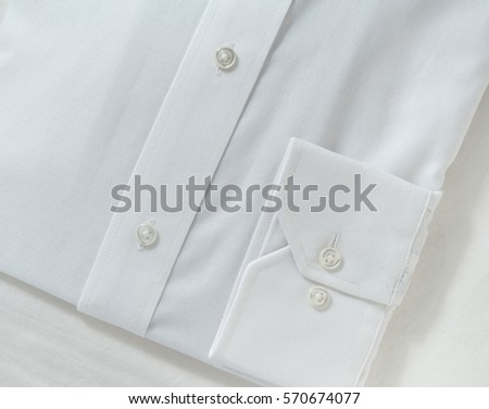 Cuff of a man's brand new white shirt. Closeup.