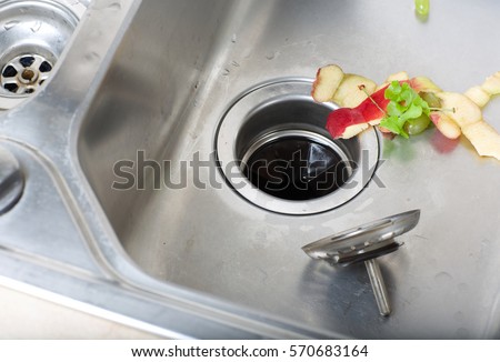 Food waste left in a sink. Closeup Royalty-Free Stock Photo #570683164
