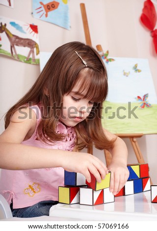 Little girl playing  block  in  preschool.