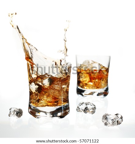 Splashing, dynamic splash of whisky with ice cube on white background