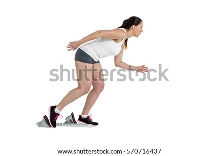 Confident athlete woman running from starting blocks on white background