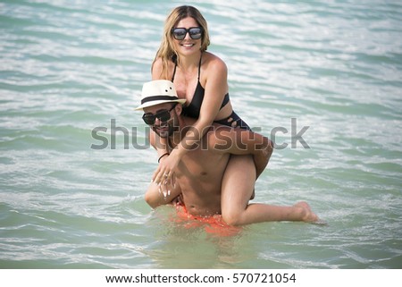 Honeymoon romantic lovers vacation on a tropical beach. Young happy lovers on romantic travel honeymoon having fun on vacation summer holidays romance.