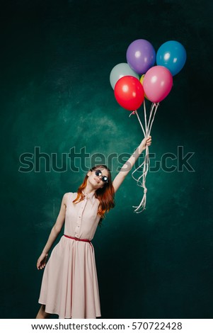 Young woman flying in the air a little ball.