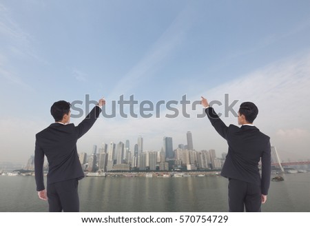 Back Rear View of Two Business Men point hand finger to target growth sale achieve top concept, background financial center sky scrapper high building and river ocean view
