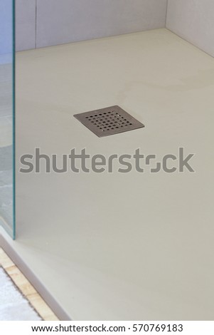 Shower drain box grate on a shower base. Royalty-Free Stock Photo #570769183