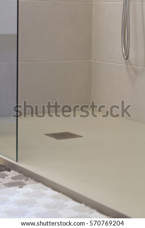 Shower drain box grate on a shower base. Royalty-Free Stock Photo #570769204