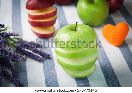 kitchen table with stack of slice green apple  on cutting board - healthy eating and dieting food, concept of health care lifestyle.