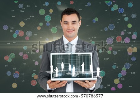 Portrait of smiling businessman holding laptop with graphics against digitally generated background