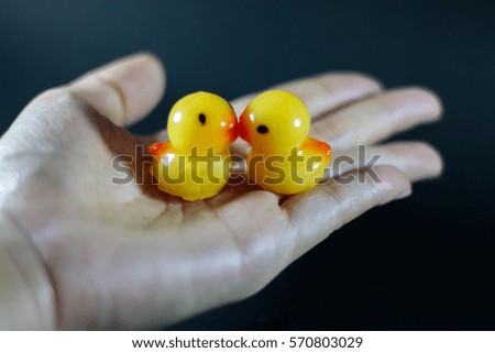 Yellow ducks in hand