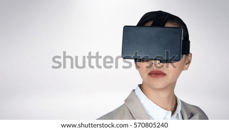 Close-up of business woman wearing vr headset against white background