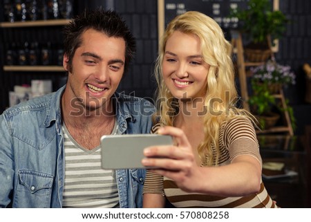 Couple taking a selfie in a coffee shop