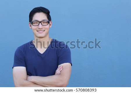 Portrait of a handsome Asian man with glasses crossing his arms Royalty-Free Stock Photo #570808393