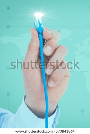 Close-up of hand holding computer cable against digital composite background