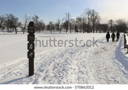 trial walking sign in the snow in a park in winter