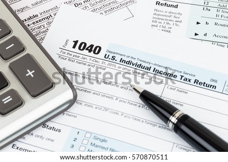 Tax form with pen and calculator