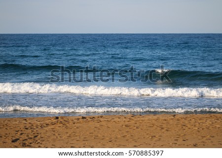 Clear blue sea water with waves and beach.