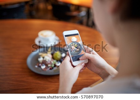 food, new nordic cuisine, technology and people concept - woman with smartphone photographing chocolate ice cream dessert with blueberry kissel, honey baked fig and greek yoghurt at cafe