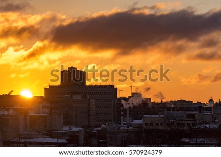 Sunrise over a big city, colorful sky, sun, building. High resolution picture