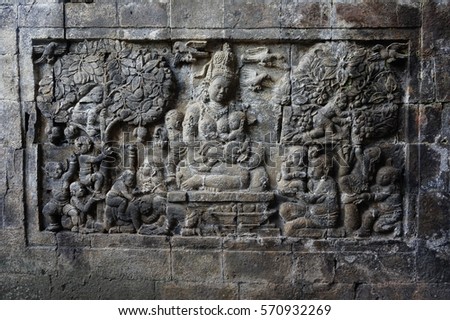 relief sculpture on the wall of a Buddhist temple in indonesia Royalty-Free Stock Photo #570932269