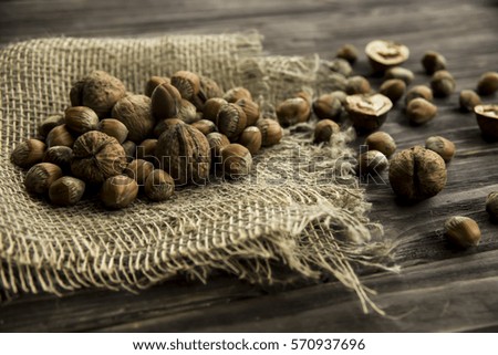 hazelnuts and walnuts in shell and without shell on sackcloth